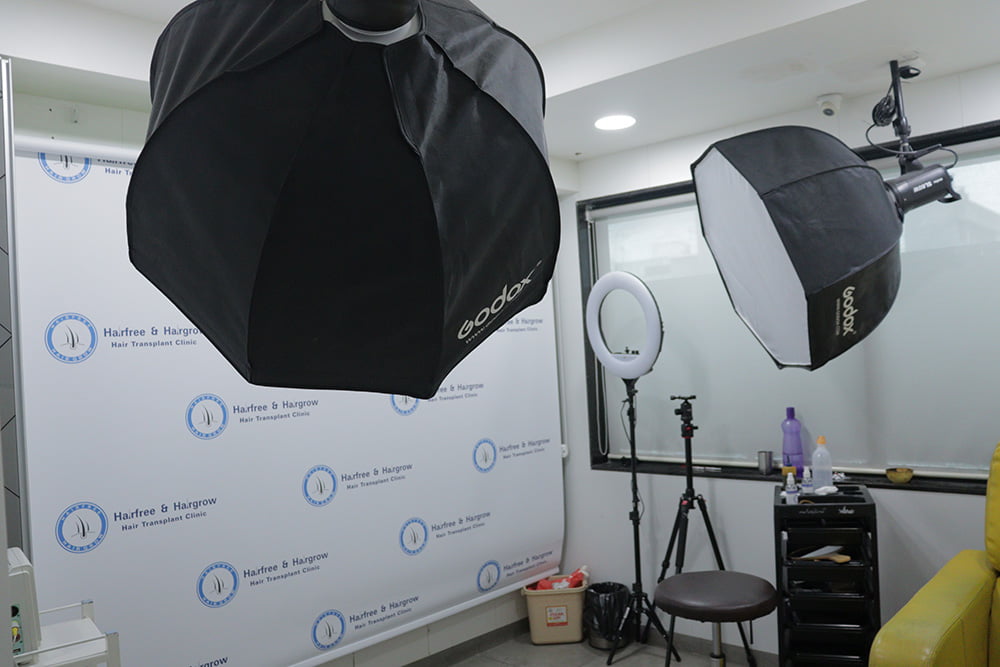 patient testimonial recording studio with studio lights and hairfree & hairgrow hair transplant clinic background at hairfree hairgrow