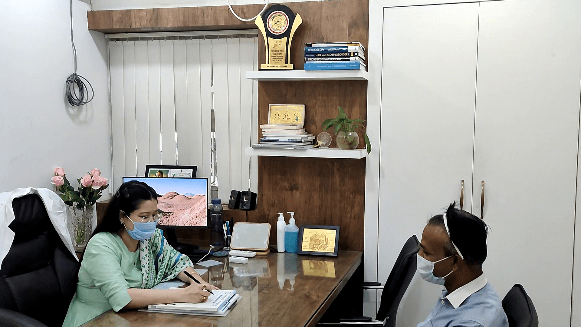 female hair loss doctor consulting patient with male hair loss at vadodara clinic of hairfree and hairgrow clinic